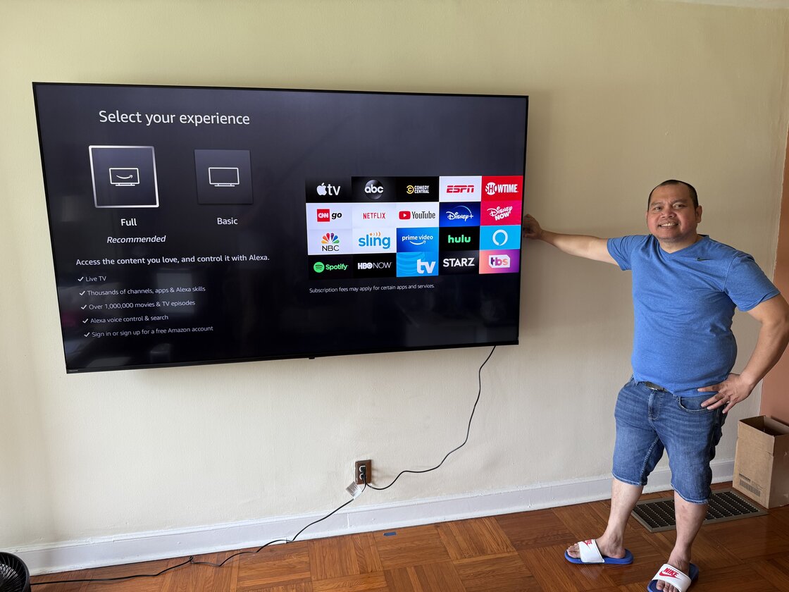 Mounting an 85-inch TV on a cinder block wall. Photo with a happy customer