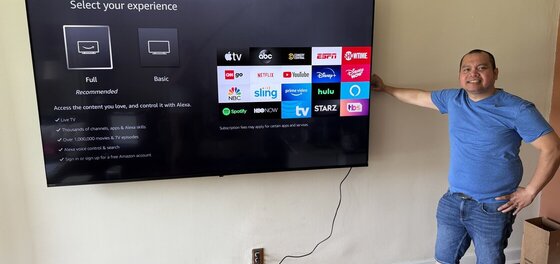 Mounting an 85-inch TV on a cinder block wall. Photo with a happy customer