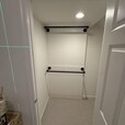 Closet clothing rods. The mounting area was reinforced with wood supports to provide a secure attachment point for the rods.